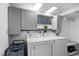 Bright laundry room with white washer and dryer, gray cabinets, and storage at 4505 S Yosemite St # 125, Denver, CO 80237