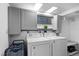 Functional laundry room with white appliances, upper cabinets, and convenient storage at 4505 S Yosemite St # 125, Denver, CO 80237