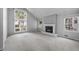 Bright and spacious living room with a fireplace, neutral carpet, and large windows offering ample natural light at 4505 S Yosemite St # 125, Denver, CO 80237