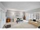 Bright living room with neutral carpet, light gray walls, and glass doors at 4505 S Yosemite St # 125, Denver, CO 80237