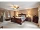 Main bedroom with a ceiling fan, cozy carpet, and warm, inviting decor at 4505 S Yosemite St # 125, Denver, CO 80237