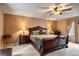 Large main bedroom with decorative bed, side tables, and a ceiling fan at 4505 S Yosemite St # 125, Denver, CO 80237