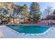 Community pool with a cover, surrounded by trees and picnic area at 4505 S Yosemite St # 125, Denver, CO 80237