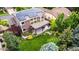 Aerial view of the home showcasing solar panels, backyard with a patio and lush landscaping at 8410 S Oak St, Littleton, CO 80127
