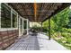 Back patio area with an awning, outdoor furniture, and a landscaped yard at 8410 S Oak St, Littleton, CO 80127