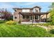 Spacious backyard featuring a lush lawn, mature trees, a well-maintained patio with a pergola at 8410 S Oak St, Littleton, CO 80127