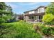 Spacious backyard featuring a lush lawn, a cozy pergola-covered patio, and a play area with a trampoline at 8410 S Oak St, Littleton, CO 80127
