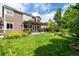 Beautiful backyard with a pergola-covered patio, lush green lawn, and mature landscaping at 8410 S Oak St, Littleton, CO 80127