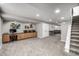 Spacious finished basement with built-in desk and cabinet, gray walls, and cozy carpeting at 8410 S Oak St, Littleton, CO 80127
