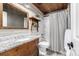 Stylish bathroom with wood accents, granite counters, and a shower with a decorative curtain at 8410 S Oak St, Littleton, CO 80127