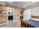 Bedroom area offering a wooden bed, wood-paneled wall, and ensuite bathroom with vanity and mirror at 8410 S Oak St, Littleton, CO 80127