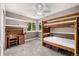 Comfortable bedroom featuring bunk beds, built-in shelving, and a bright, inviting atmosphere at 8410 S Oak St, Littleton, CO 80127