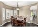 Dining area with a large table, seating for six, and window views at 8410 S Oak St, Littleton, CO 80127