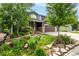 Beautiful two-story home with professional landscaping, including stone pathways and lush greenery at 8410 S Oak St, Littleton, CO 80127