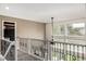 Upstairs hallway overlooks foyer and living room with wrought iron railing at 8410 S Oak St, Littleton, CO 80127