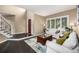 Bright living room with hardwood floors, a red door, and large windows at 8410 S Oak St, Littleton, CO 80127