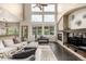 Living room with stone fireplace, media center, dark floors, and lots of natural light at 8410 S Oak St, Littleton, CO 80127