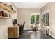 Home office with natural wood desk, decorative shelves, and plenty of natural light at 8410 S Oak St, Littleton, CO 80127
