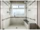 Luxurious walk-in shower with dual shower heads, bench seat, and decorative tile accents at 8410 S Oak St, Littleton, CO 80127