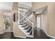 Elegant staircase with wrought iron railing and dark wood treads at 8410 S Oak St, Littleton, CO 80127