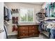 Organized walk-in closet with ample shelving, dresser, and natural light from the window at 8410 S Oak St, Littleton, CO 80127