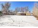 Large backyard covered in snow, view of home at 130 S Eaton St, Lakewood, CO 80226