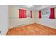 Bedroom with red curtains, brown carpet and patterned wallpaper at 130 S Eaton St, Lakewood, CO 80226