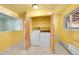 Bright laundry room with washer, dryer, and built-in shelving at 130 S Eaton St, Lakewood, CO 80226