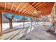 Covered patio with ceiling fan and snowy backyard view at 130 S Eaton St, Lakewood, CO 80226