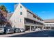 Exterior view of three-story townhouse buildings in a parking lot setting at 5250 S Huron Way # 11-206, Littleton, CO 80120