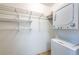 Laundry space with stacked washer and dryer units, as well as wire shelving for storage at 5250 S Huron Way # 11-206, Littleton, CO 80120