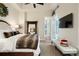 Bright bedroom featuring a plush bed, large mirror, and access to a sitting area at 2198 Avenida Del Sol, Castle Rock, CO 80104
