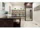 Butler's pantry with custom cabinetry, wine cooler, and ample shelving at 2198 Avenida Del Sol, Castle Rock, CO 80104