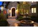 Inviting entryway with a stone arch, fountain, and pathway at 2198 Avenida Del Sol, Castle Rock, CO 80104