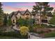 Luxury home exterior at sunset, showcasing landscaping and architectural details at 2198 Avenida Del Sol, Castle Rock, CO 80104