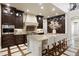 Gourmet kitchen boasts granite island, dark cabinetry, and high-end stainless steel appliances at 2198 Avenida Del Sol, Castle Rock, CO 80104