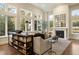 Spacious living room with large windows, fireplace, and built-in shelving at 2198 Avenida Del Sol, Castle Rock, CO 80104