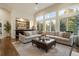 Living room features a sectional sofa, built-in bar, and large windows at 2198 Avenida Del Sol, Castle Rock, CO 80104