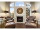 Relaxing sitting area with two leather armchairs, ottomans, and a fireplace at 2198 Avenida Del Sol, Castle Rock, CO 80104