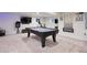 Finished basement game room with a pool table, mounted TV, exercise bike, and recessed lighting at 2187 Wynterbrook Dr, Highlands Ranch, CO 80126