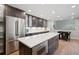 Modern kitchen featuring an island, stainless steel appliances, and dark wood cabinetry at 2187 Wynterbrook Dr, Highlands Ranch, CO 80126