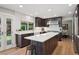 Bright, modern kitchen with white countertops, dark cabinetry, stainless steel appliances, and a large island at 2187 Wynterbrook Dr, Highlands Ranch, CO 80126