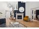 Stylish living room with a fireplace, high ceilings, modern decor, and hardwood floors at 2187 Wynterbrook Dr, Highlands Ranch, CO 80126