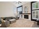 Spacious living room with a fireplace, tall windows, comfortable seating, and a high ceiling at 2187 Wynterbrook Dr, Highlands Ranch, CO 80126