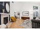 Bright and airy living room featuring a fireplace, hardwood floors, and contemporary furniture at 2187 Wynterbrook Dr, Highlands Ranch, CO 80126