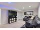 Finished basement living room featuring a large TV, leather sofa, and recessed lighting at 2187 Wynterbrook Dr, Highlands Ranch, CO 80126