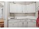 Practical mud room area with storage cabinets and sink at 2187 Wynterbrook Dr, Highlands Ranch, CO 80126