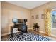 Home office with multiple monitors, patterned rug, and natural light at 2187 Wynterbrook Dr, Highlands Ranch, CO 80126