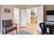 Bright office space with a view to the foyer, stairs, and a nearby powder room at 2187 Wynterbrook Dr, Highlands Ranch, CO 80126