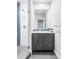 Sleek bathroom with modern fixtures, white tile, and a glass-enclosed shower at 2435 S High St, Denver, CO 80210